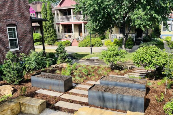 The unplanted mild steel vegetable beds, meandering rectilinear paver path and new perennial prairie garden freshly installed in the Milwaukee Avenue garden.