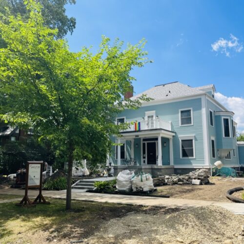 A stately Neo-Georgian home, freshly painted a robin's egg blue, sits on a barren lot showing signs of continued construction in the Kenwood neighborhood of Minneapolis.