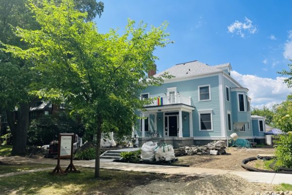 A stately Neo-Georgian home, freshly painted a robin's egg blue, sits on a barren lot showing signs of continued construction in the Kenwood neighborhood of Minneapolis.